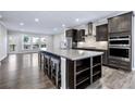 Spacious open floor plan kitchen with stainless appliances, island seating, and dark wood floors at 1017 Brandsford Nw St, Atlanta, GA 30318