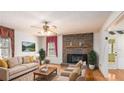 Comfortable living room with a brick fireplace, plush seating, and plenty of natural light at 2601 Round Ridge Rd, Loganville, GA 30052