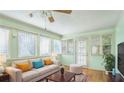Bright sun room with a neutral sofa, wood floors, and plenty of natural light at 2601 Round Ridge Rd, Loganville, GA 30052