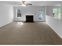 Large living area with cozy fireplace and neutral carpet, ready for personalization at 3227 Diamond Blf, Union City, GA 30291