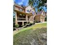 Two-story house with a wrap-around porch, stone accents, and manicured landscaping at 89 Grand Oak Way, Dallas, GA 30157