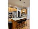 Kitchen island with granite countertops and stainless steel appliances at 89 Grand Oak Way, Dallas, GA 30157