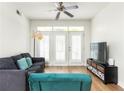 Living room with hardwood floors, large windows, and comfortable seating at 390 17Th Nw St # 1063, Atlanta, GA 30363