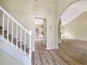 Inviting foyer with wood flooring, staircase, and archway leading to living spaces at 277 Players Cir, Fayetteville, GA 30215