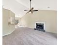 Bright living room with a vaulted ceiling, ceiling fan, and a modern fireplace at 277 Players Cir, Fayetteville, GA 30215