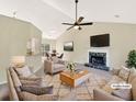Spacious living room featuring a fireplace, ceiling fan, and comfortable seating at 277 Players Cir, Fayetteville, GA 30215