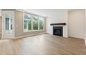 Bright living room featuring a modern fireplace and large windows for natural light at 5210 Ginger Rose Ct, Cumming, GA 30028