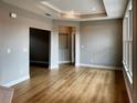Living room featuring hardwood floors, recessed lights, and abundant natural light at 313 Sassafras Way, Holly Springs, GA 30115