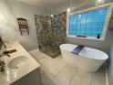 Elegant bathroom with double vanity, soaking tub, and walk-in shower at 7655 Abbey Glen Dr, Cumming, GA 30028