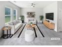 Bright living room with modern furniture, neutral colors, and natural light from large windows at 55 Cherohala Ct, Covington, GA 30016
