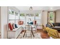 Built-in window seat dining area with glass table and colorful pillows at 980 Moreland Se Ave, Atlanta, GA 30316