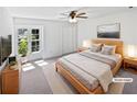 Bright staged bedroom showcasing a large window, and a ceiling fan at 7131 Forest Ln, Union City, GA 30291