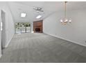 Spacious living room featuring skylights, a fireplace, and neutral carpeting at 7131 Forest Ln, Union City, GA 30291