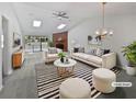 Bright living room featuring a vaulted ceiling, skylights, and a stylish fireplace at 7131 Forest Ln, Union City, GA 30291