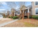 Street view of townhomes, each featuring a private front porch and landscaped entrance at 905 Freedom Ln, Roswell, GA 30075