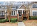 Attractive townhome featuring a covered porch and neat front yard at 905 Freedom Ln, Roswell, GA 30075