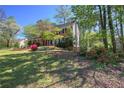 Attractive brick home with mature trees, colorful flower beds, and a sprawling lawn at 2921 Wickford Nw Dr, Kennesaw, GA 30152