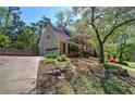 View shows a brick home with an attached garage and a long driveway; basketball hoop in backyard at 2921 Wickford Nw Dr, Kennesaw, GA 30152