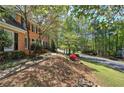 Landscaped front yard view shows the home's location on a tree-lined street at 2921 Wickford Nw Dr, Kennesaw, GA 30152