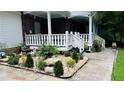 Beautifully landscaped front yard with rocks, plants and a decorative water feature at 2100 Indian Shoals Dr, Loganville, GA 30052