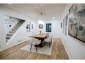 Bright dining room featuring hardwood floors and a modern chandelier above a wooden table at 1466 Hardin Ave, Atlanta, GA 30337