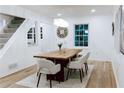 Bright dining room featuring hardwood floors and a modern chandelier above a wooden table at 1466 Hardin Ave, Atlanta, GA 30337