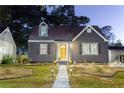 Charming home with gray siding, black shutters, a welcoming yellow front door, and stone walkway at 1466 Hardin Ave, Atlanta, GA 30337