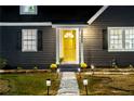 Charming home featuring a walkway and a bright yellow front door for a welcoming entrance at 1466 Hardin Ave, Atlanta, GA 30337