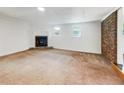 Bright living room featuring a cozy fireplace, a large carpet, and a brick wall at 741 Prince Ave, Marietta, GA 30062