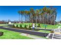 Street view of Champion's Run community showcasing lush greenery and the 'New Homes' sign at 8588 Preakness Pass, Lithonia, GA 30058