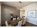 Elegant dining room features a wood table, chandelier, and built-in wall paneling at 500 Pearl St, Cumming, GA 30040