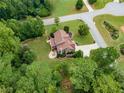 Stunning aerial view of a home with lush green landscaping and a circular driveway on a verdant lot at 52 Olivia Ct, Palmetto, GA 30268
