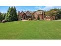 Spacious front yard of brick and stone home with luxurious curb appeal at 2145 Jones Phillips Rd, Dacula, GA 30019