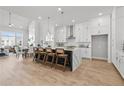 Bright, modern kitchen with white cabinetry, stainless steel appliances, and a large center island at 480 Broom Dr, Cumming, GA 30040