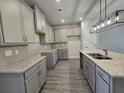 Modern kitchen with granite countertops and gray cabinets at 6206 Ripple Way # 89, South Fulton, GA 30349