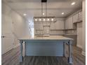 Modern kitchen with a large island, granite countertops, and stainless steel appliances at 6206 Ripple Way # 89, South Fulton, GA 30349