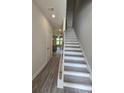 Bright foyer with wood-look flooring and a staircase leading to the upper level at 6206 Ripple Way # 89, South Fulton, GA 30349