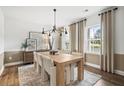 Bright dining room features a large wooden table, chandelier, and neutral colors at 6076 Marigold Way, Atlanta, GA 30349