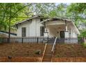 Charming white bungalow with a black picket fence and landscaping at 1738 Hosea L Williams Ne Dr, Atlanta, GA 30317