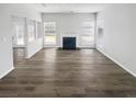 Bright and airy living room featuring a fireplace and stylish, modern flooring at 6235 Marbut Farms Trl, Lithonia, GA 30058