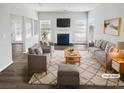 Bright living room with large windows, a cozy fireplace and neutral decor at 6235 Marbut Farms Trl, Lithonia, GA 30058