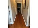 Hallway with hardwood floors leading into the living room with a fireplace at 2198 Vinings North Se Ln, Smyrna, GA 30080