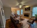 View of the bright living room with hardwood floors, fireplace, and a ceiling fan at 2198 Vinings North Se Ln, Smyrna, GA 30080
