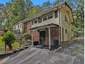 A multi-level home with a side entry and covered parking, accented by brick and light siding at 2497 Mobley Se Ct, Atlanta, GA 30315