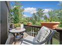 Cozy patio area with comfortable seating, perfect for enjoying the surrounding nature views with a pet cat at 3200 Rim Cove Dr # 192, Cumming, GA 30041