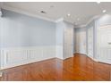 Open living room with hardwood floors, white trim, baseboards and doors, plus light blue-painted walls at 3403 Stratford Commons, Decatur, GA 30033