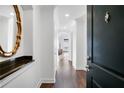 Elegant foyer with dark wood floors, white walls, and decorative mirror; a welcoming entrance to a stylish home at 3445 Stratford Ne Rd # 3601, Atlanta, GA 30326