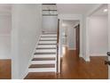 Interior view of a grand staircase with wooden steps and a barn door at 105 Dockstreet Aly, Peachtree City, GA 30269