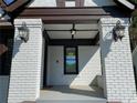 Quaint front porch with brick columns and detailed lighting fixtures at 1677 S Gordon Sw St, Atlanta, GA 30310