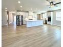 Spacious kitchen with stainless steel appliances, white cabinets, a center island, and a ceiling fan at 738 Crossroad Ct, Powder Springs, GA 30127